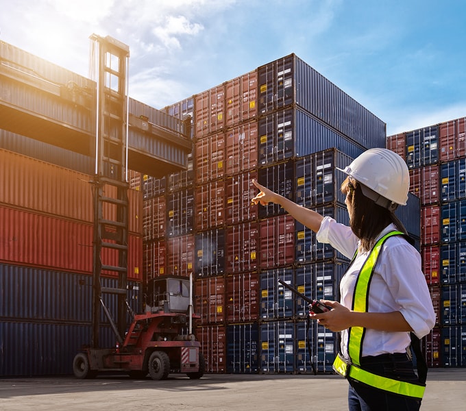 An employee doing stock control with a tablet in a warehouse